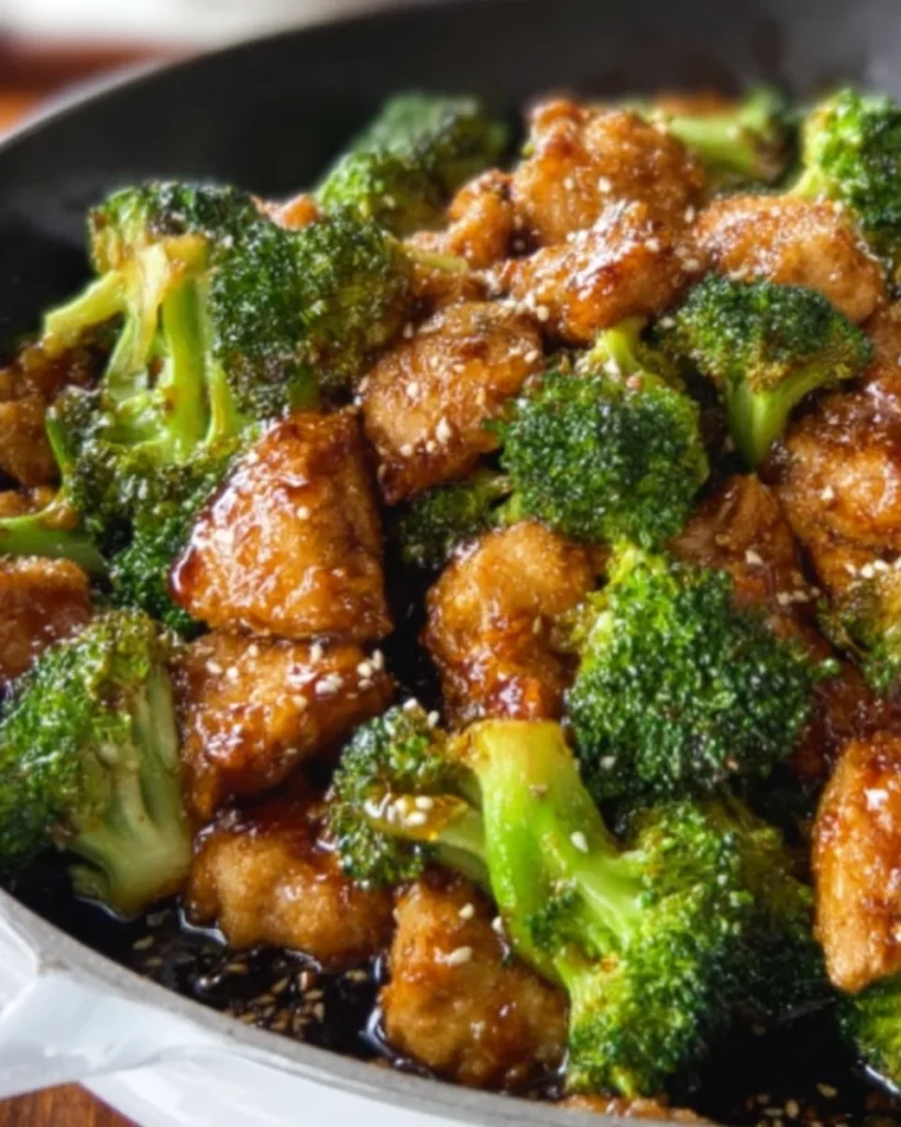 Delicious Honey Sesame Chicken served with broccoli and sesame seeds.