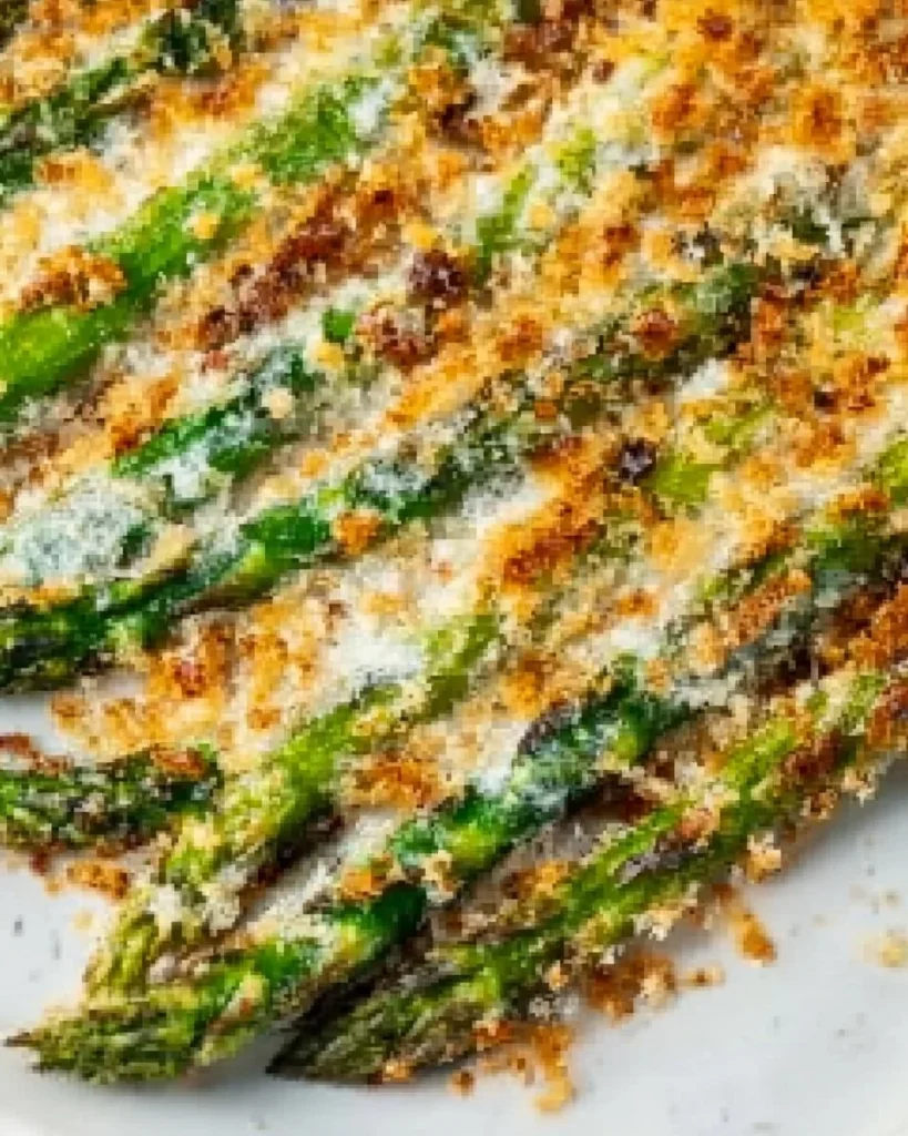 Plate of roasted asparagus topped with Parmesan cheese