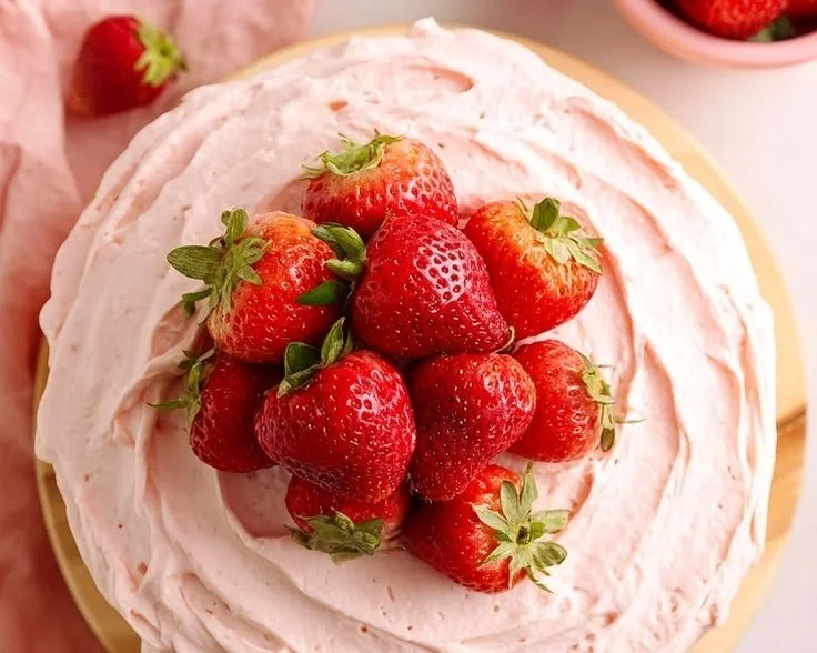 Low sugar strawberry cake topped with fresh strawberries and whipped cream