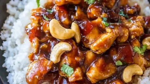Delicious Spicy Cashew Chicken from Cheesecake Factory served with rice and vegetables.