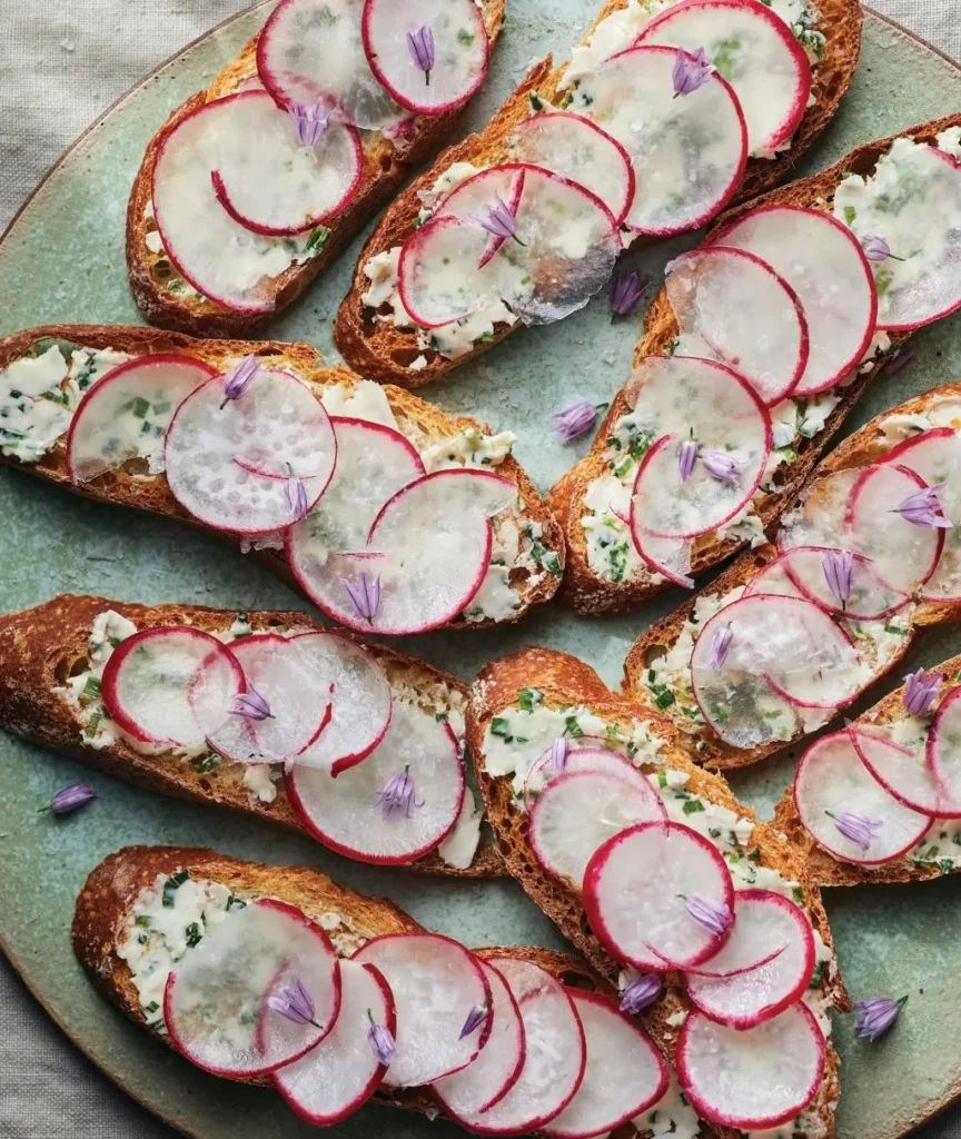 Delicious chive butter toasts topped with fresh radishes on a rustic plate.