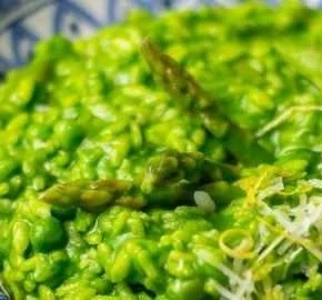 Delicious green risotto with peas and asparagus served in a bowl