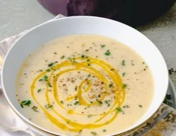 Delicious bowl of homemade Potato Leek Soup topped with fresh herbs.