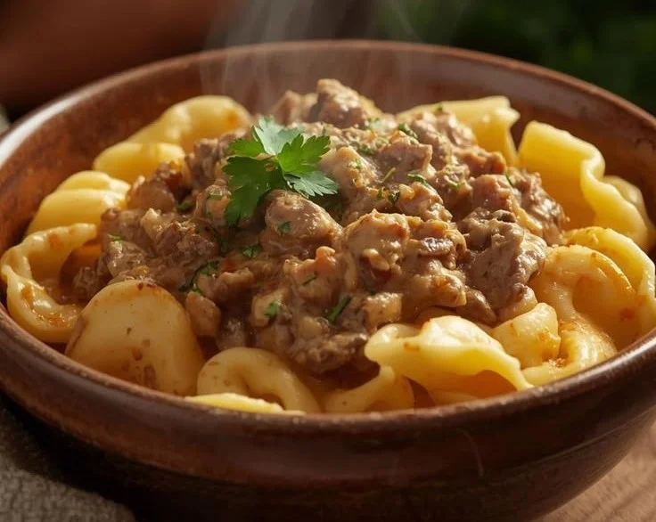 Creamy Beef Stroganoff Tortellini in a skillet with fresh herbs