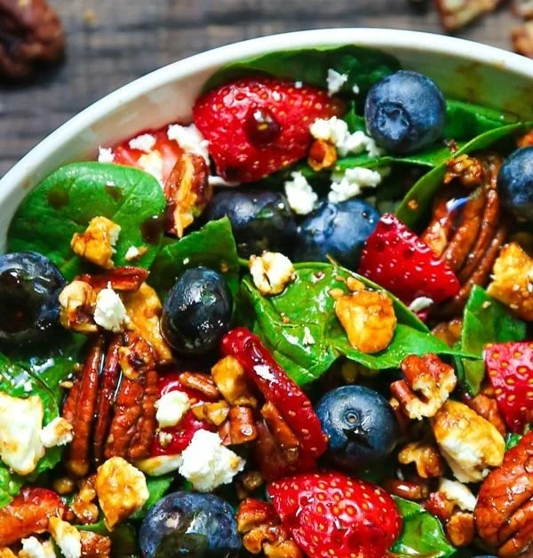 Fresh strawberry spinach salad served in a bowl with vibrant colors.