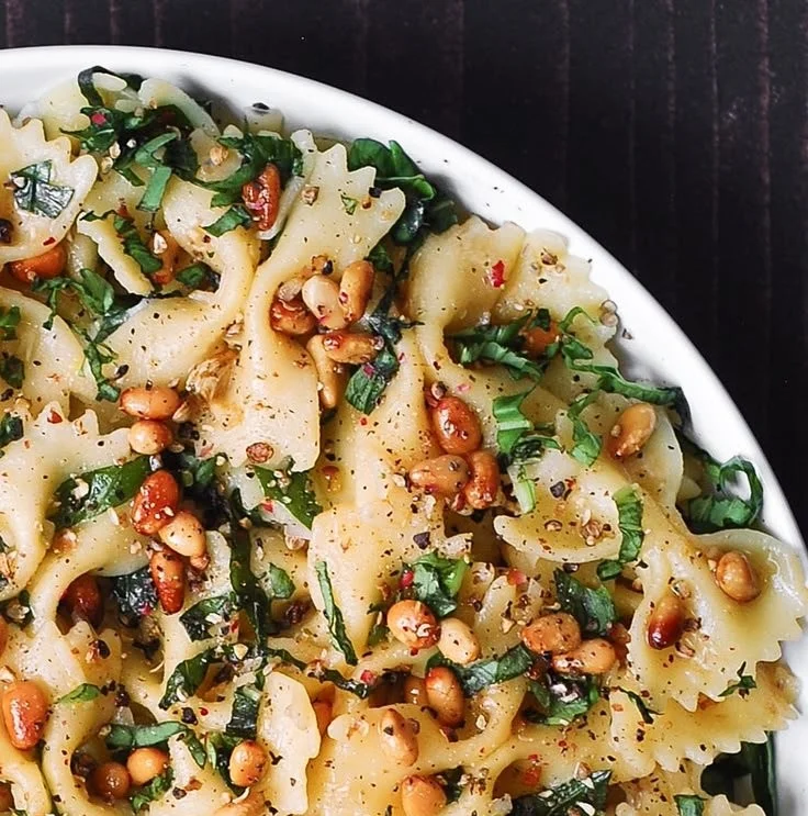 Plate of Basil Pasta with Lemon Garlic Butter Sauce garnished with herbs.
