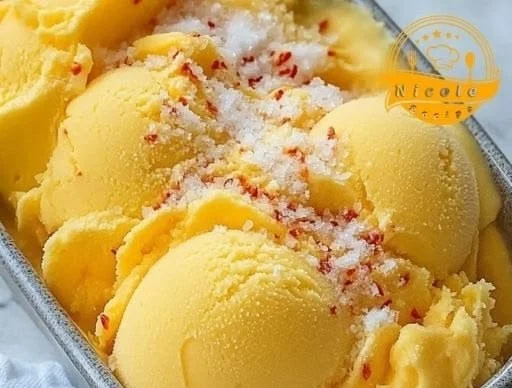 Bowl of Chili Lime Mango Sorbet garnished with lime slices and chili flakes
