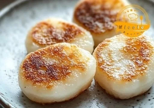Crispy pan-fried Japanese potato mochi served on a plate for cozy dining.