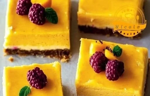 Delicious vegan mango cheesecake bars topped with fresh mango slices.