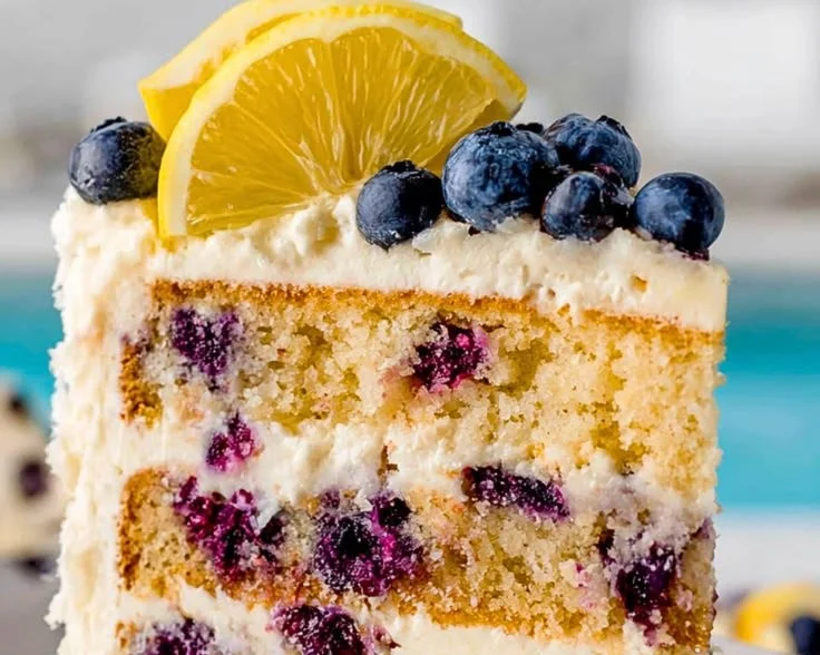 Lemon blueberry layer cake with fresh blueberries and lemon zest topping