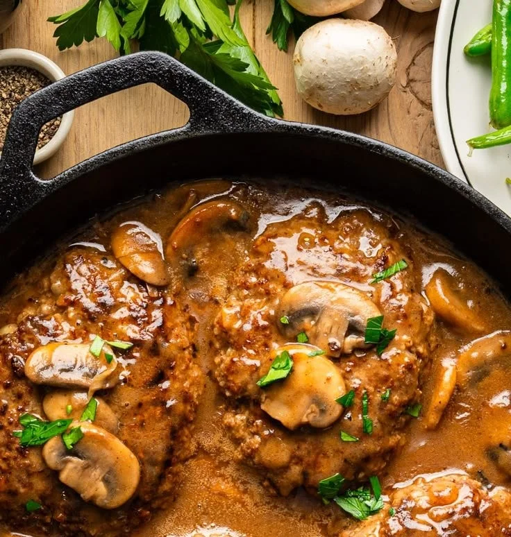 Delicious Salisbury Steak served with brown gravy and a side of mashed potatoes