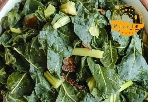 Bowl of flavorful homemade Southern collard greens served with a rustic backdrop.