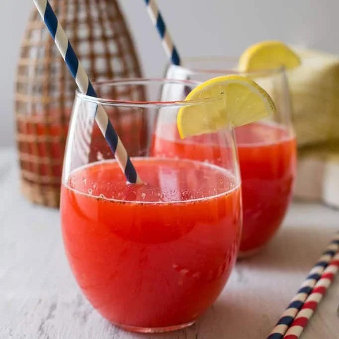 Glass of summer strawberry lemonade with fresh strawberries and lemon slices
