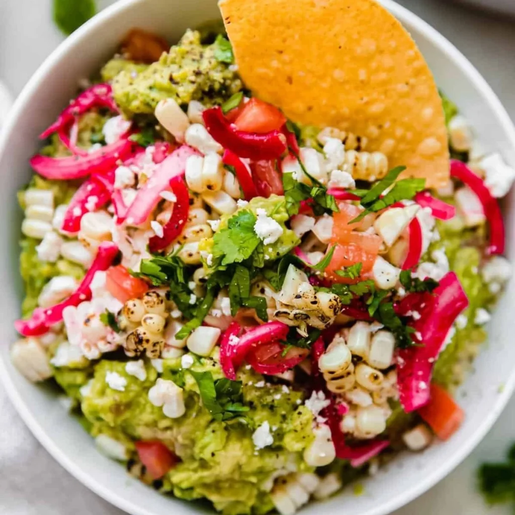 Bowl of homemade guacamole with fresh ingredients like avocados and lime.