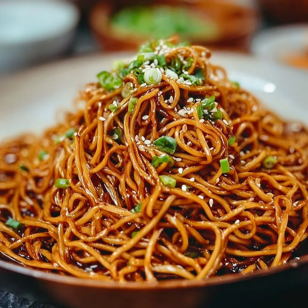 Delicious bowl of savory soy sauce pan fried noodles garnished with vegetables
