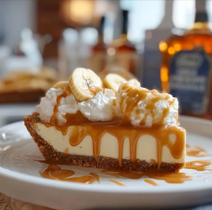 Delicious banana whiskey caramel cream pie served on a dessert plate.