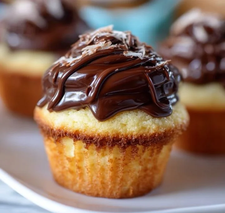 Delicious Boston Cream Pie Cupcakes topped with chocolate and vanilla cream